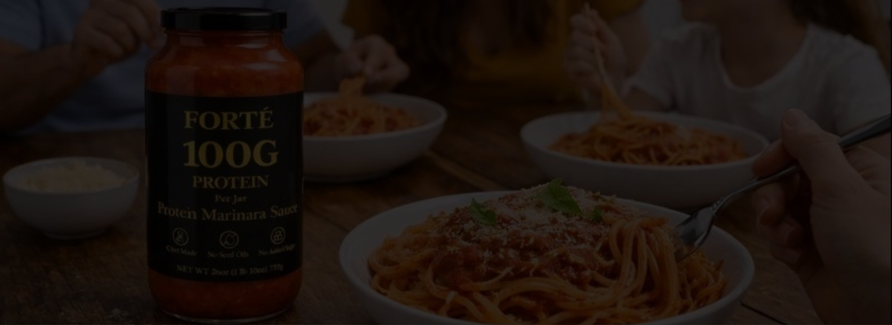 High protein marinara sauce with 100g of protein per jar next to family eating at dinner table with protein pasta sauce on their food